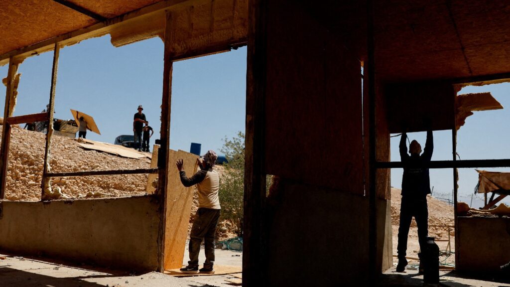 Palestinian Bedouins dismantle a house before fleeing while settler violence surges near Jericho in the Israeli occupied West Bank July 4 2025. REUTERS