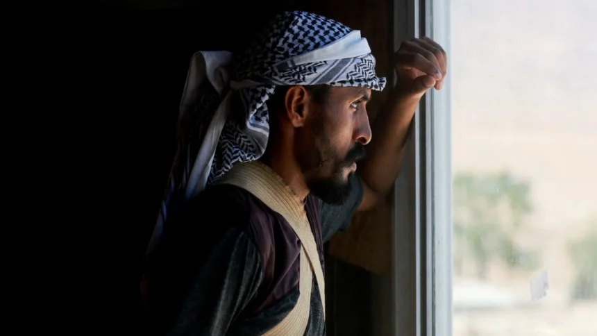 A Palestinian Bedouin stands inside his home as others flee while settler violence surges near Jericho in the Israeli occupied West Bank July 4 2025.jpg